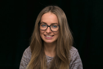 Fototapeta premium portrait of a beautiful girl on a black background.