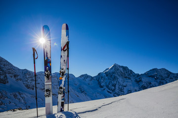 Ski in winter season, mountains and ski touring backcountry equipments on the top of snowy...
