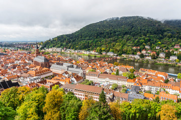 Europe culture concept - panoramic city skyline birds eye aerial view under dramatic sun and morning blue cloudy sky in Heidelberg, Germany.