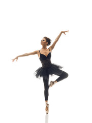 Fototapeta premium Young beautiful ballet dancer isolated over white background