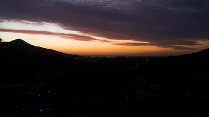 Aerial drone view of beautiful sunset sky above tropical island