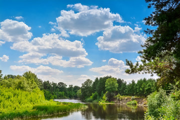 Gorgeous summer landscape - Ukrainian river, blue sky, clouds.