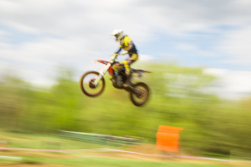 Fototapeta premium Biker on motocross jump in motion