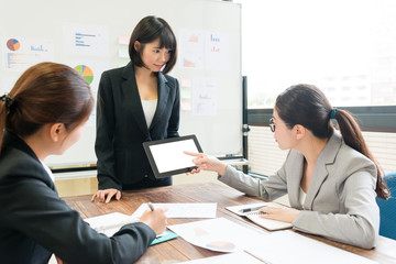 Fototapeta premium female office worker using mobile digital tablet