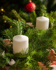 Christmas card. White candles in a green Christmas tree on background festive decoration. Christmas table decoration. Homemade gifts