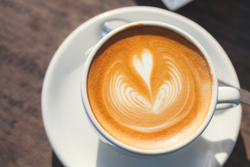 Cup of coffee latte, with heart shape.