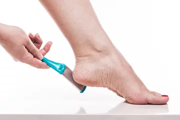 Zelfklevend Fotobehang care for dry skin on the well-groomed feet and heels with the help of tools pedicure graters Foot © Ivan Traimak