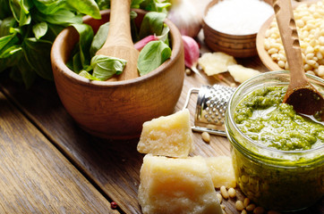 Pesto sauce ingredients and utensils on wood table
