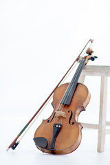 Violin leaned by a stool