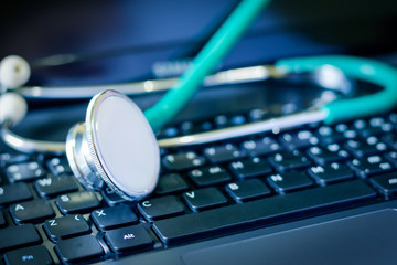 Obraz na płótnie Canvas Stethoscope over a laptop computer keyboard,analysis data of health concept.