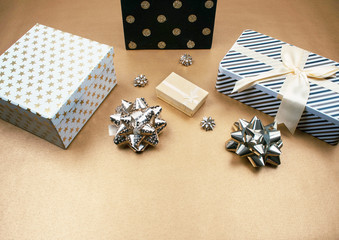 Modern gifts on a gold background with copy space.
