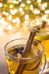 Mulled cider in glass on wooden table
