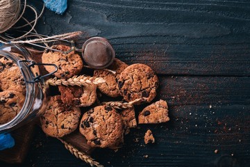 Cookies with chocolate. On a wooden background. Top view. Free space for your text.