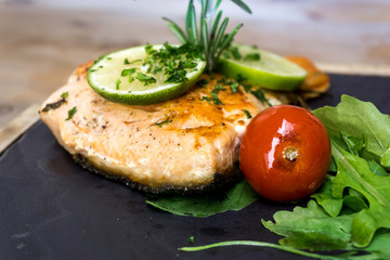 grilled salmon and lemon - french cuisine dish with tomato and salmon