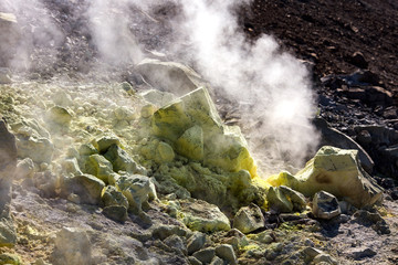 Sulfur haze and crystals on the rocks. Volcano or Vulcano Island in the archipelago of Aeolian Islands close to Sicily - Italy.