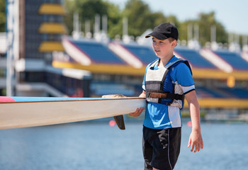 A boy in a row club in Poland. Hard work on a sport form in rowing and canoeing. Athletic teenager.