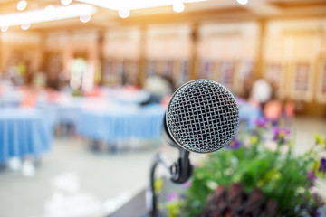 Blurred of microphones in seminar room, talking speech in conference hall light with microphone and...