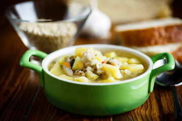 chicken soup with pearl barley in a bowl