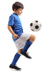 Fototapeta premium Little footballer juggling a football