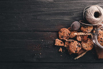 Cookies with chocolate. On a wooden background. Top view. Free space for your text.