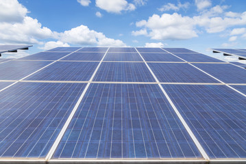 array of  polycrystalline silicon solar cells in solar power plant turn up skyward absorb the sunlight from the sun use light energy to generate electricity on blue sky background