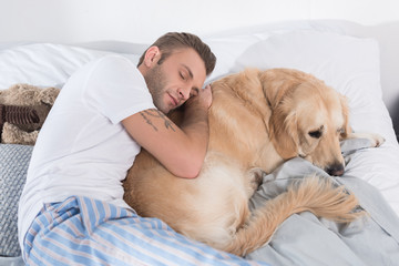 Man sleeping and hugging dog
