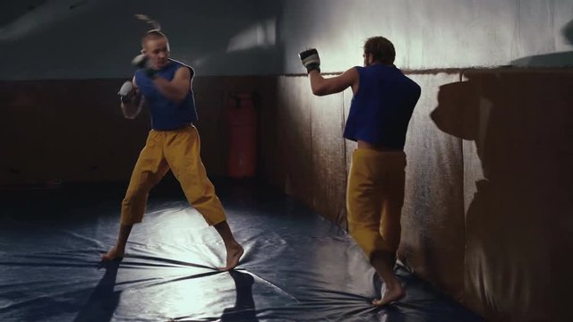 Free fighters in uniform workout in the gym in 4K