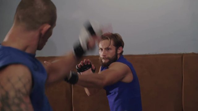 Free fighters in uniform workout in the gym in 4K