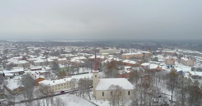Aerial view of old church afer snowfall. Cross close up.