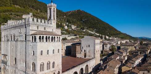 Obraz premium Gubbio, Italy. One of the most beautiful small town in Italy. Drone aerial view of the city center, main square and the historical building called Palazzo dei Consoli