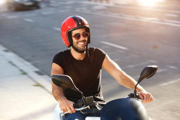 Portrait of happy man with helmet and sunglasses on motorcycle ride