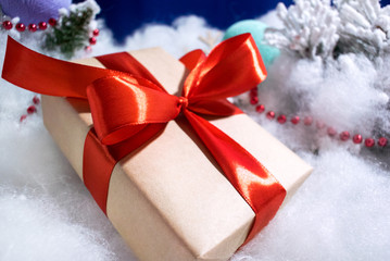 Closeup Gift box with red bow on blue background	