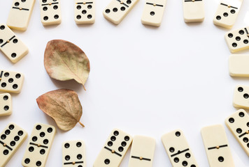 Domino blocks on corners with autumn fall leaves on white