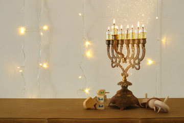 Image of jewish holiday Hanukkah background with traditional spinnig top, menorah (traditional candelabra)