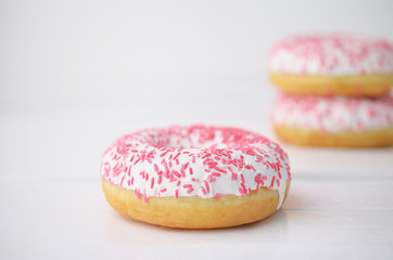 Donuts with icing on whiote background. Sweet donuts