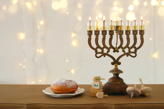 Image of jewish holiday Hanukkah background with traditional spinnig top, menorah (traditional candelabra)