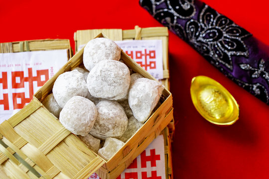Traditional chinese food called Moci placed in bamboo containers captured from top angle in red background.