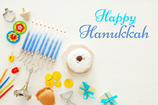Top view image of jewish holiday Hanukkah background with traditional spinnig top, menorah (traditional candelabra)