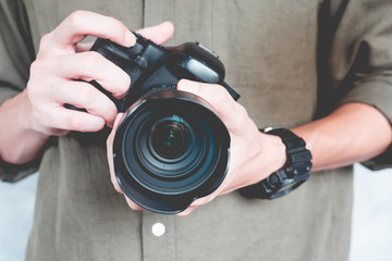 Close up of casual man is holding a camera, Photography Concept.