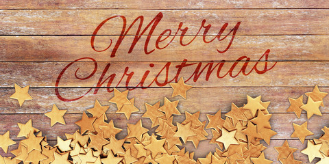 Scattered gold confetti stars on wooden planks - Merry Christmas