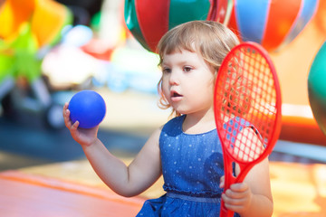 Little kid on playground, playing tennis