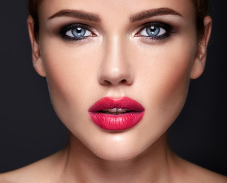 Portrait of beautiful girl model with evening makeup and romantic hairstyle. Red lips