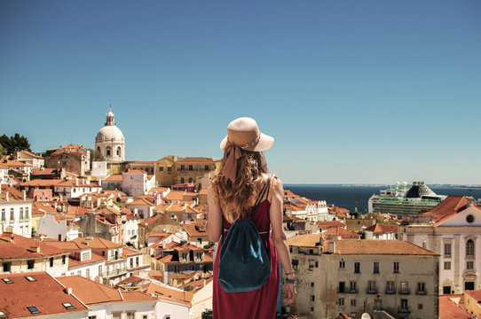 Yougn woman in red dress traveling in Portugal