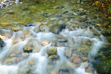 Stream leading into Preists Lake in Northern Idaho taken with a long time exposure to blur the...