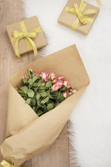 Large luxury bouquet of roses and gifts on a fur carpet