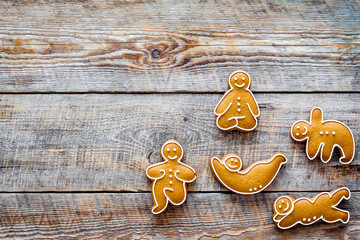 Gingerbread cookies in shape of yoga asanas on wooden background top view copyspace