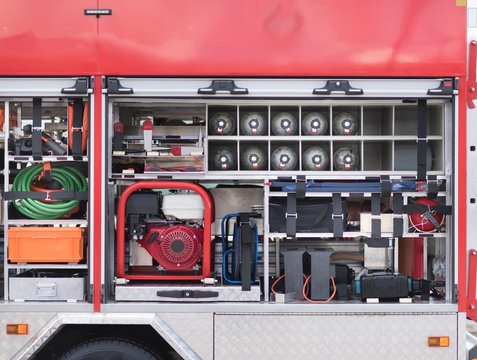 Compartment of rolled up fire hoses on a fire engine. Rescue fire truck equipment.