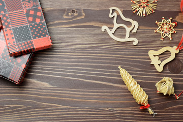 Christmas gift box, food decor and christmas decorations on a dark wooden background. Top view with copy space.