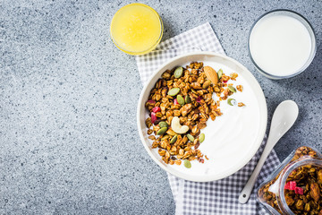 Healthy high protein grain free granola yogurt breakfast on dark concrete background. Top view, space for text. 