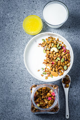Paleo gluten free granola yogurt brealfast on dark concrete background. Top view, space for text. 